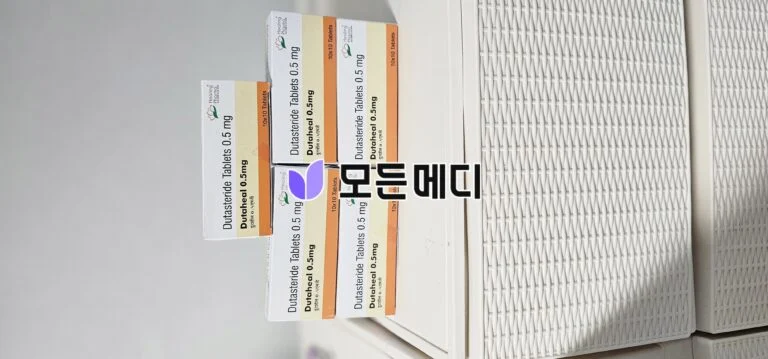 Stack of boxes labeled Dutasteride Tablets 0.5 mg arranged on a white surface.