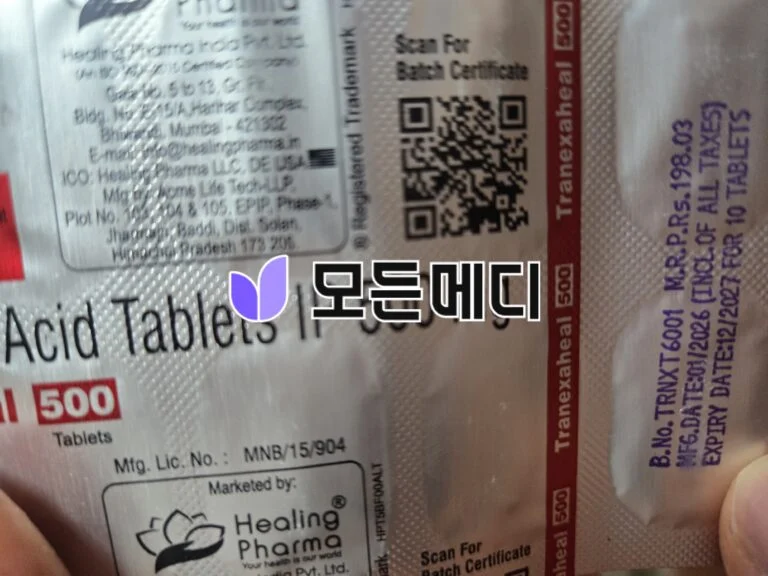 Close-up of a medication package label with a QR code, red vertical border, and printed text about tablets; includes a Healing Pharma logo partially visible.